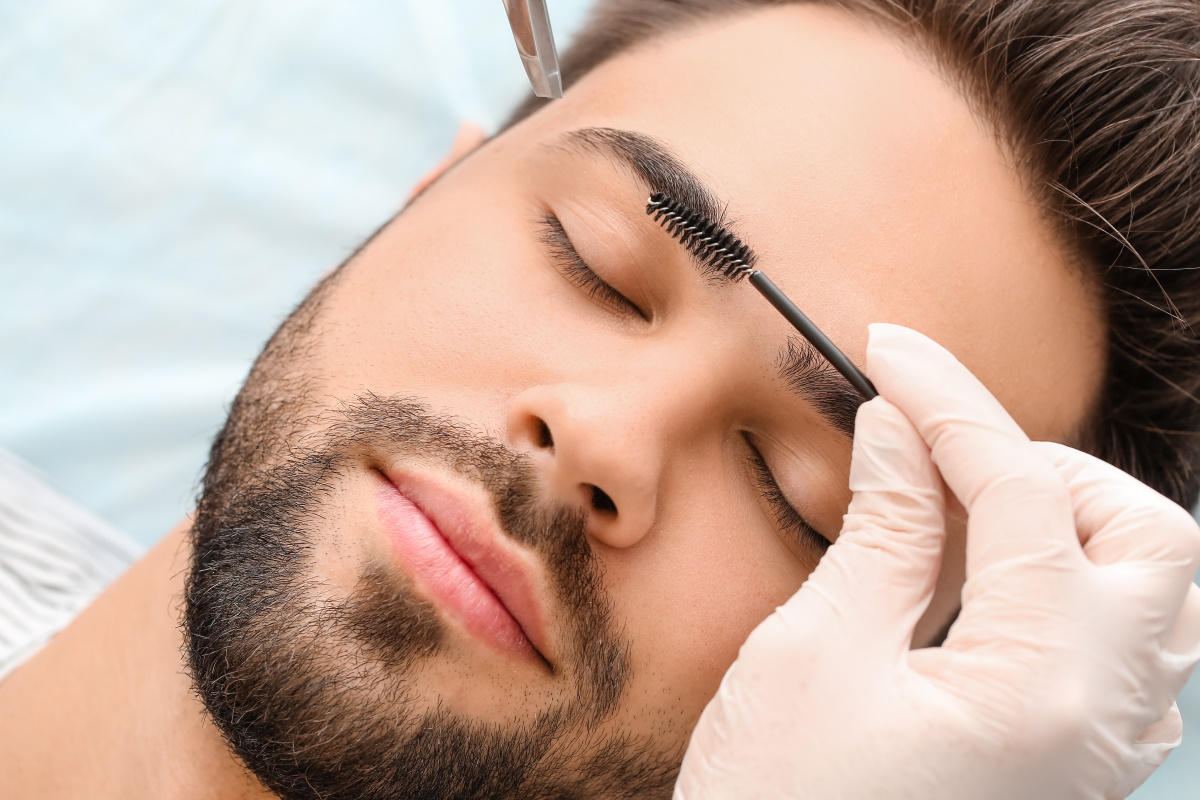 man getting eyebrow shaping treatment
